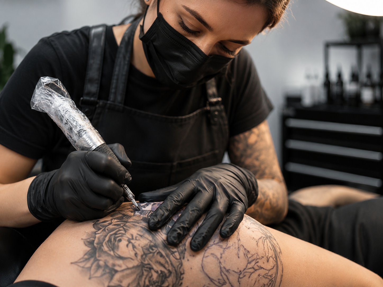 Tattoo professional using Black Nitrile Gloves in a studio